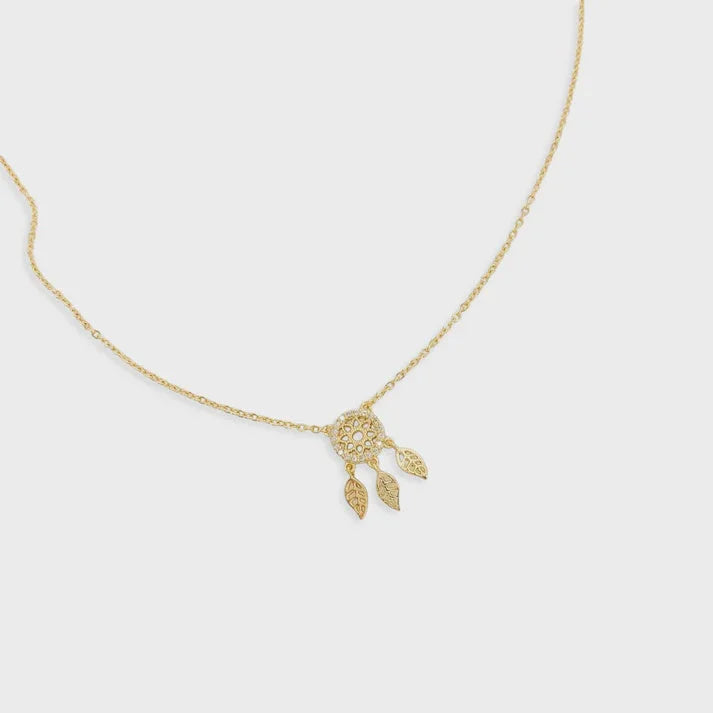 Gold-toned dream catcher necklace with white diamonds and three leaf-shaped charms