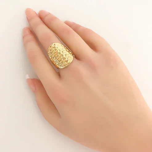 Water resistant gold adjustable oval hammered-texture statement ring on a hand