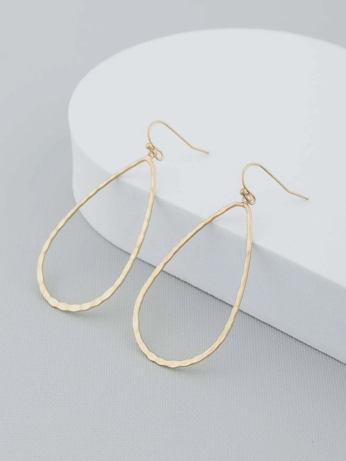 Gold-toned teardrop-shaped hoop earrings with wire hooks, perfect water drop earring gold