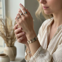 Gold and turquoise beaded stretch bracelet with geometric pattern from Shop Daisy