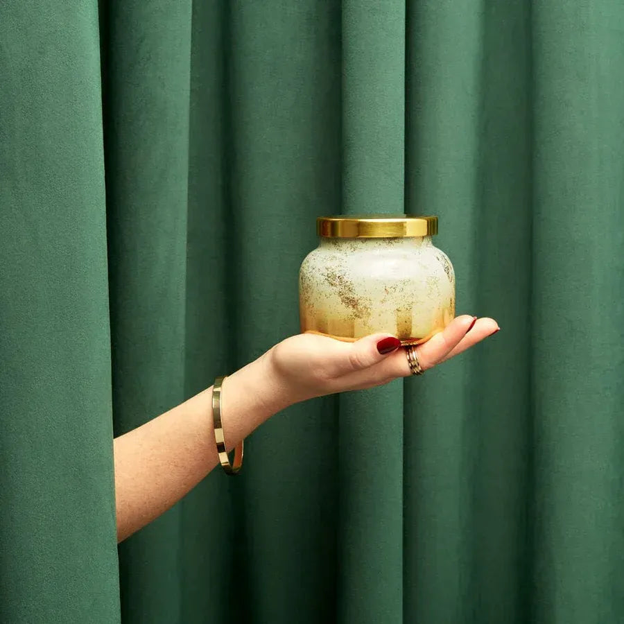 Gold and white frosted glass candle jar with brass lid from Volcano Glimmer Signature Candle