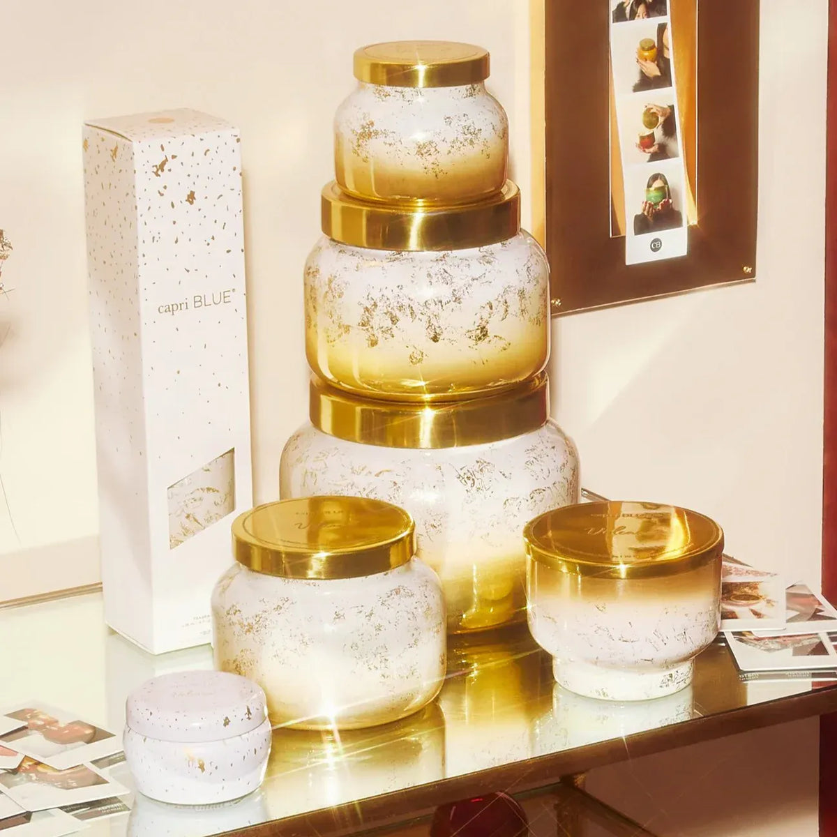 Gold and white speckled glass Volcano Glimmer Signature Candle jars with golden lids