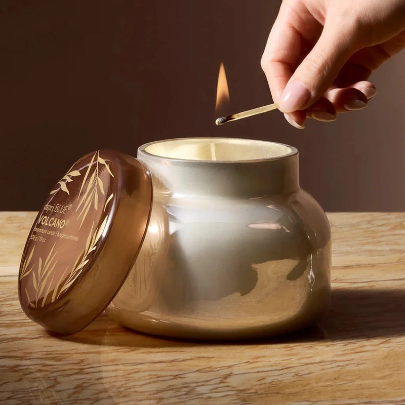 Golden volcano candle jar with leaf design and brown lid from Capri Blue Volcano Autumn Glow 19oz signature