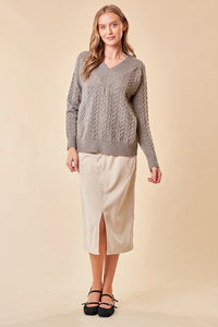 Gray cable-knit v-neck sweater with beige midi skirt and black flats for women’s boho chic clothing