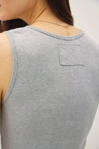 Gray ribbed sleeveless tank top with raw seam and square patch, ideal for women’s boho chic clothing from Shop Daisy
