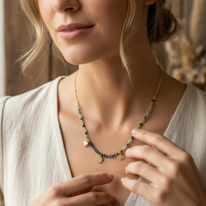 Earthy green gold charm necklace with beaded design and pendant accents