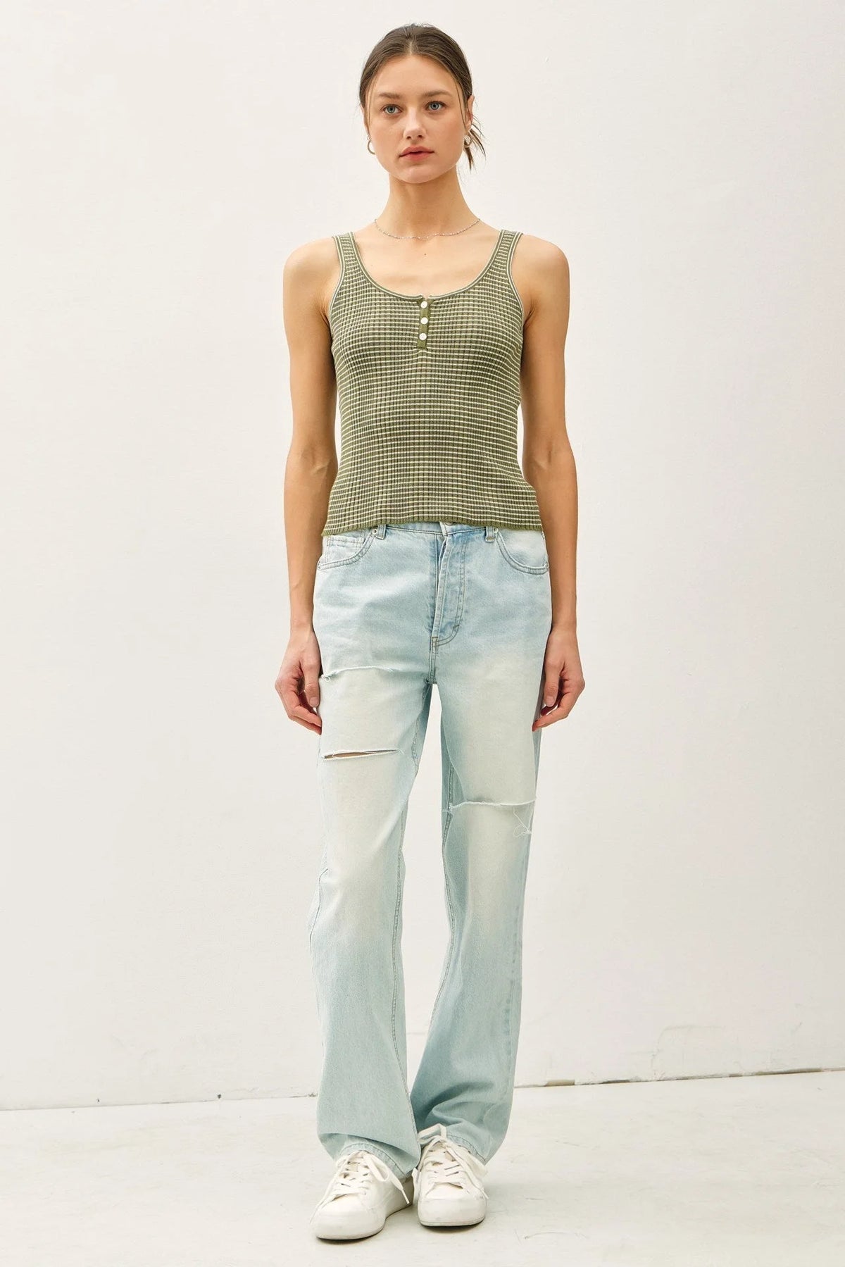 Green and beige striped knit button-up Henley tank top with distressed wide-leg jeans