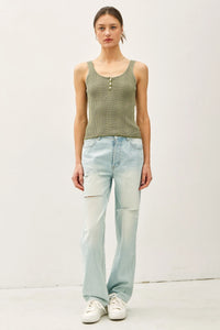 Green and beige striped knit button-up Henley tank top with distressed wide-leg jeans