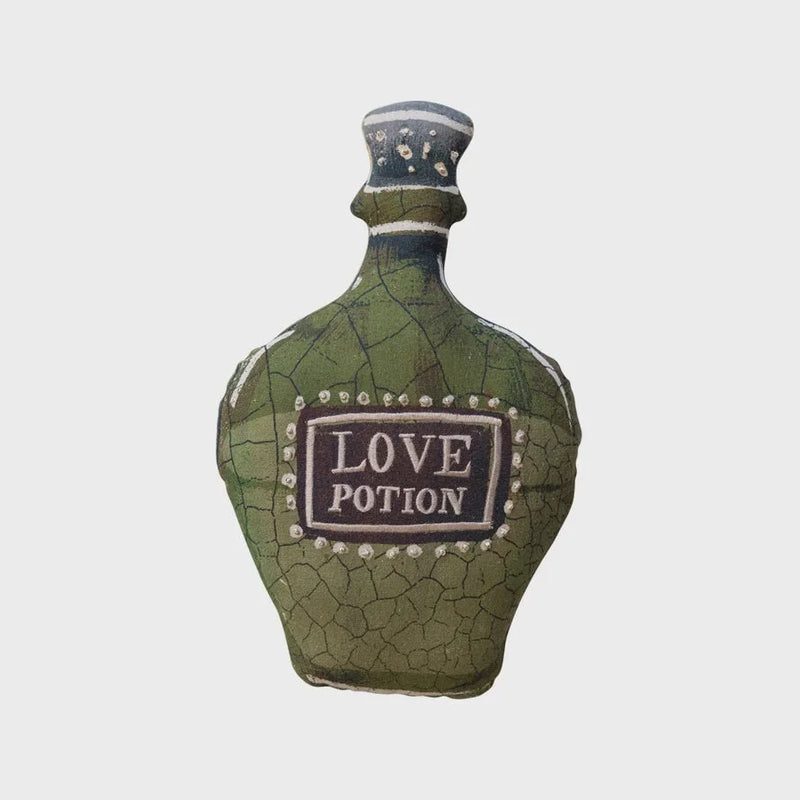 Green cotton potion bottle shaped pillow labeled LOVE POTION with decorative details