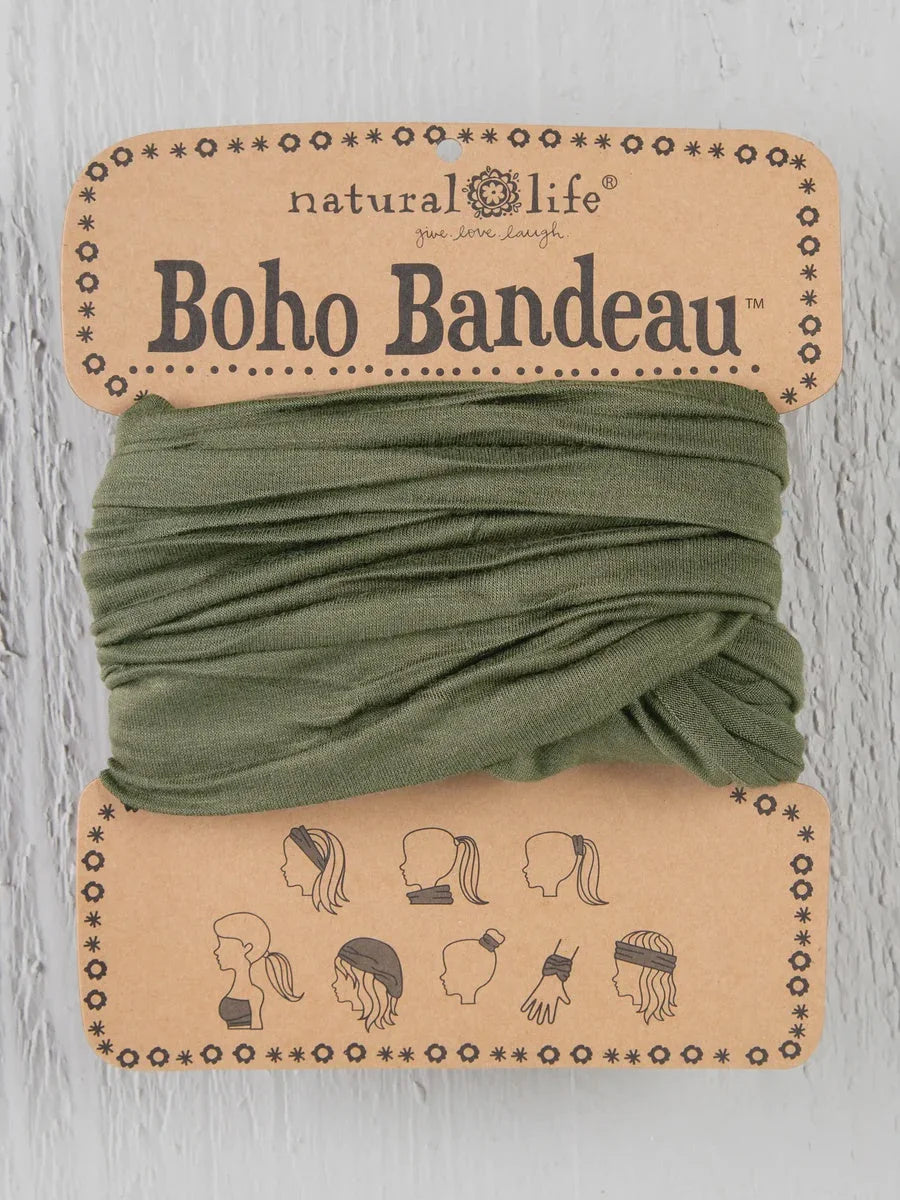 Green Boho bandeau headband with a small black and white dog design on it