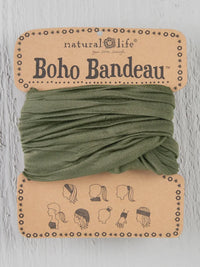 Green Boho bandeau headband with a small black and white dog design on it