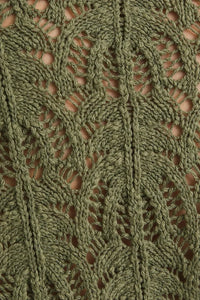 Green knitted lace fabric from the FRONT TIE BELL SLEEVE OPEN KNIT CARDIGAN with bell sleeves