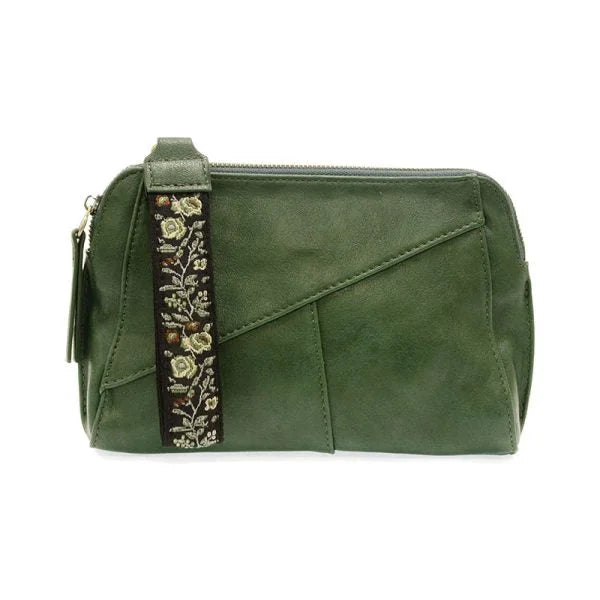 Green vegan leather handbag featuring a decorative floral woven wristlet strap