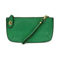 Green leather wristlet clutch featuring card slots from Shop Daisy’s women’s boho chic collection