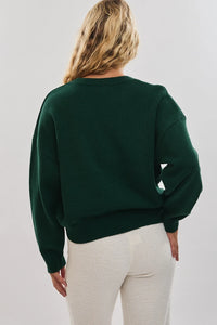 Green Gingerbread Graphic Sweater with oversized fit and ribbed cuffs