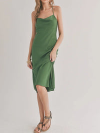 Green flowy slip dress with cowl neck, thin straps, and mid-length hemline