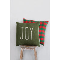 Green cotton knit throw pillow with JOY embroidery, paired with a checkered holiday pillow