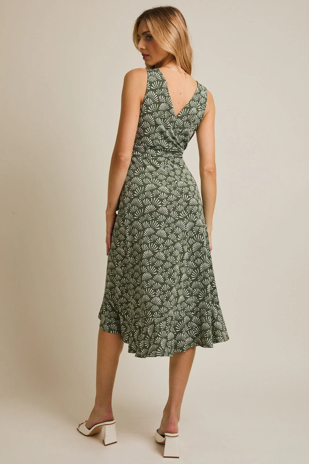 Green V-neck sleeveless midi dress with waist tie, shell pattern, and ruffled hem