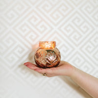 Hand holding a Soy-Blend Sweet Grace Candle, a best-selling fragrance candle