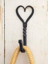 Heart-shaped metal wall hook with rope, featuring a durable iron wall design