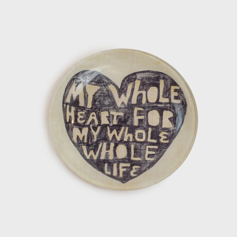 Heart-shaped text on small round decoupage jewelry plate featuring romantic design