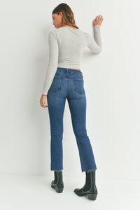 High-waisted cropped flare denim styled with a white top and chic black boots