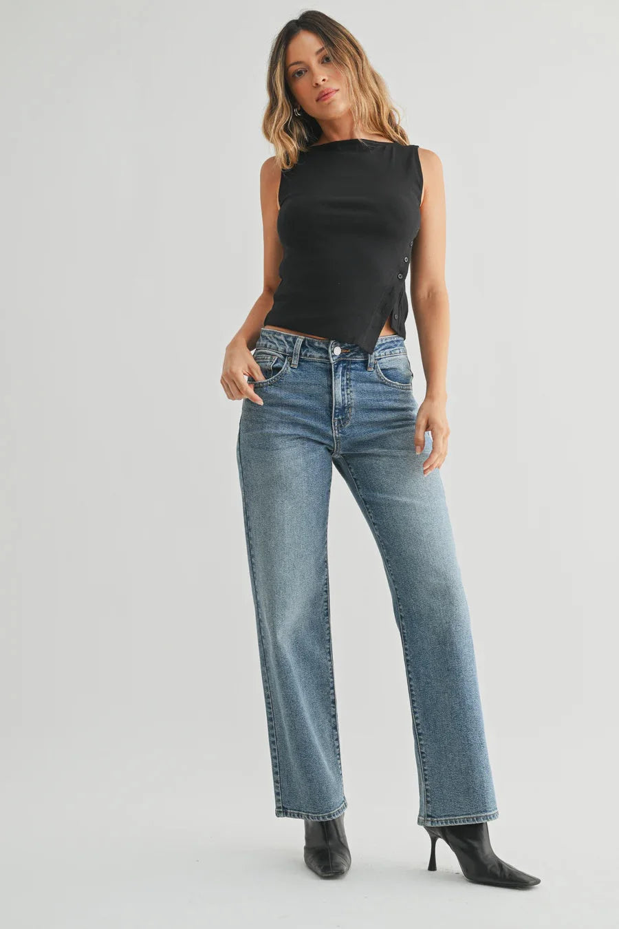 Loose low rise stretch straight denim jeans in light wash with distressed details