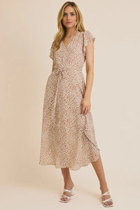 Knee-length light-colored animal print midi dress with short sleeves and tie waist
