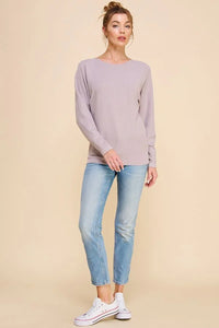 Lavender crewneck sweater with soft chevron pattern paired with light-wash jeans and sneakers