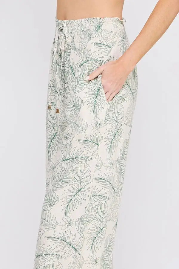 Leaf-patterned drawstring pants with smocked tie waist and wide leg silhouette