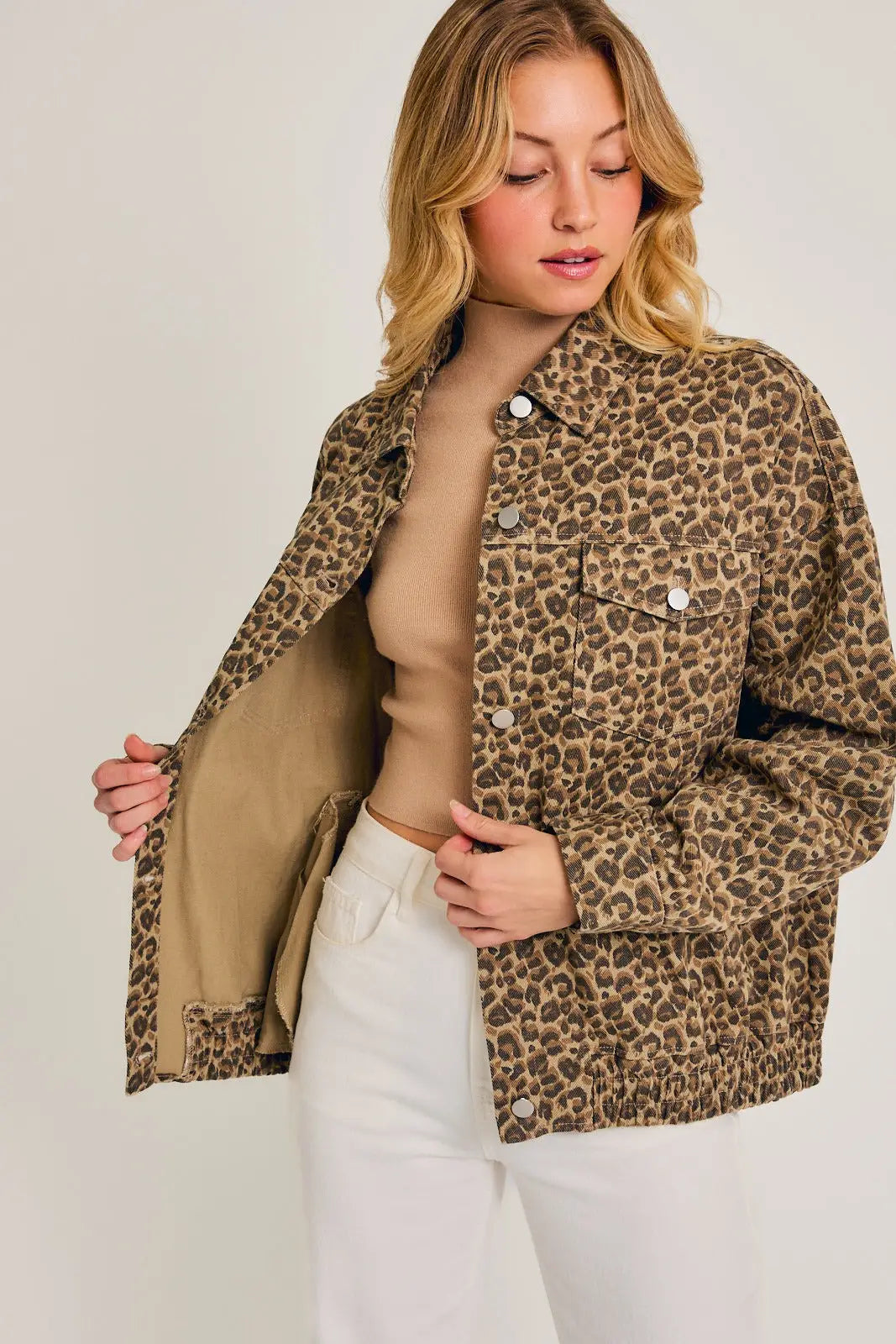 Leopard print denim jacket featuring button closures and patch pockets, a cheetah print oversized style