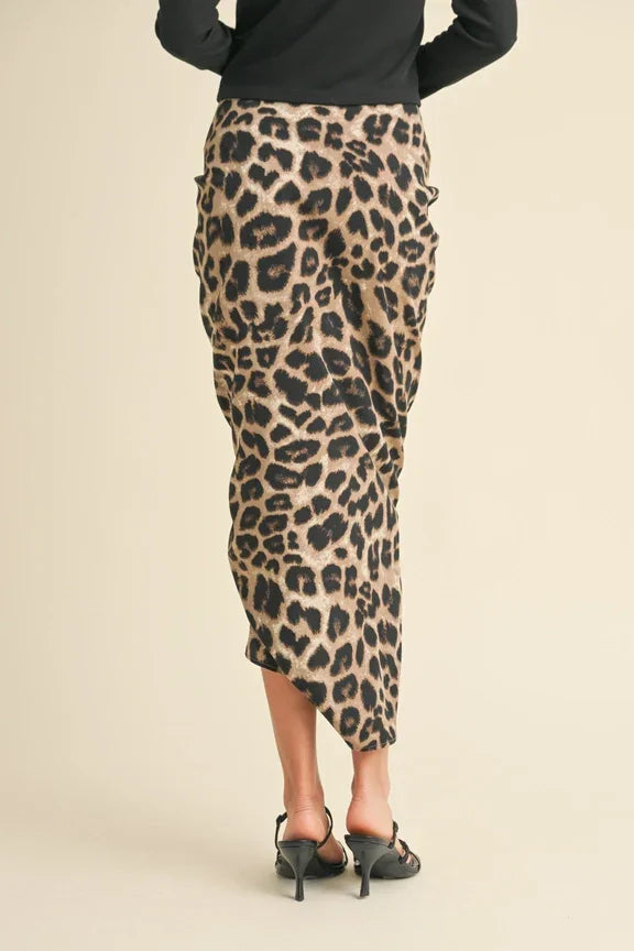 Leopard print midi skirt showcasing elegant ruching and a form-fitting silhouette