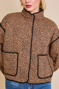 Leopard print puffer jacket with black trim, a stylish animal print jacket for women