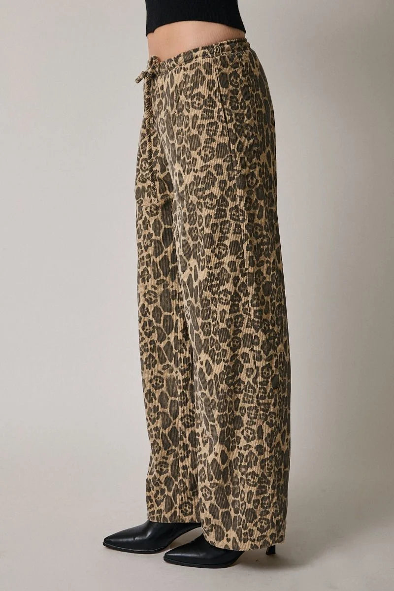 Leopard print wide-leg pants with draw string waist and black leather ankle boots