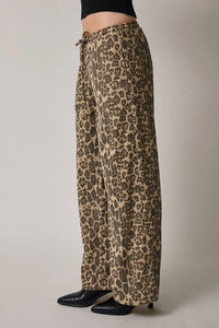Leopard print wide-leg pants with draw string waist and black leather ankle boots