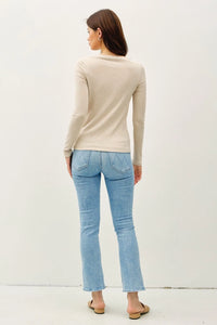 Light beige long sleeve knit top with basic boat neck and fitted silhouette