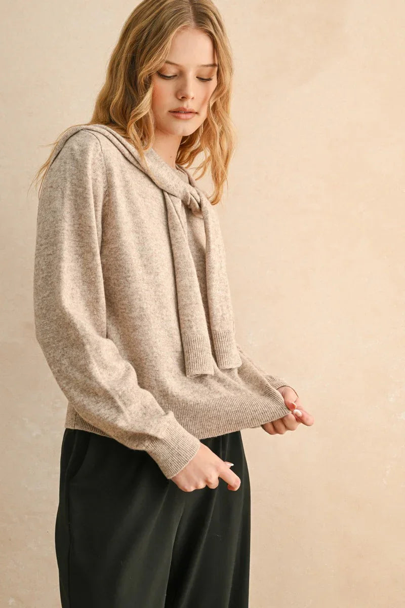 Light beige round neck sweater with long sleeves and elegant tie-neck detail