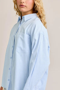 Light blue button-down shirt from Shop Daisy, perfect for women’s boho chic clothing