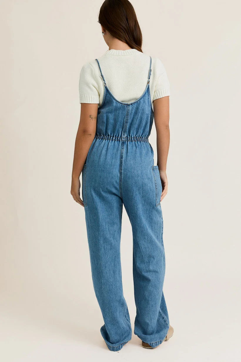 Light blue denim overalls with bow ties, ideal for women’s boho chic clothing from Shop Daisy