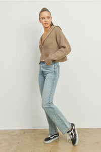 Drama collar V neck sweater with light blue distressed denim jeans and black Vans sneakers