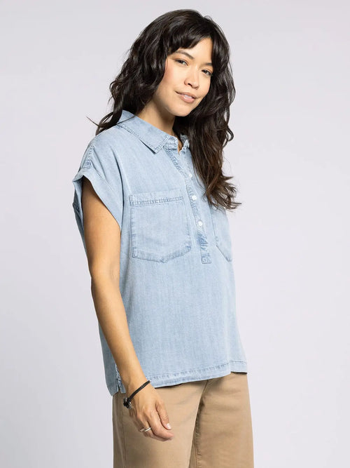 Light blue denim short-sleeved shirt from THREAD AND SUPPLY EVELYN TOP, perfect for women’s boho chic clothing