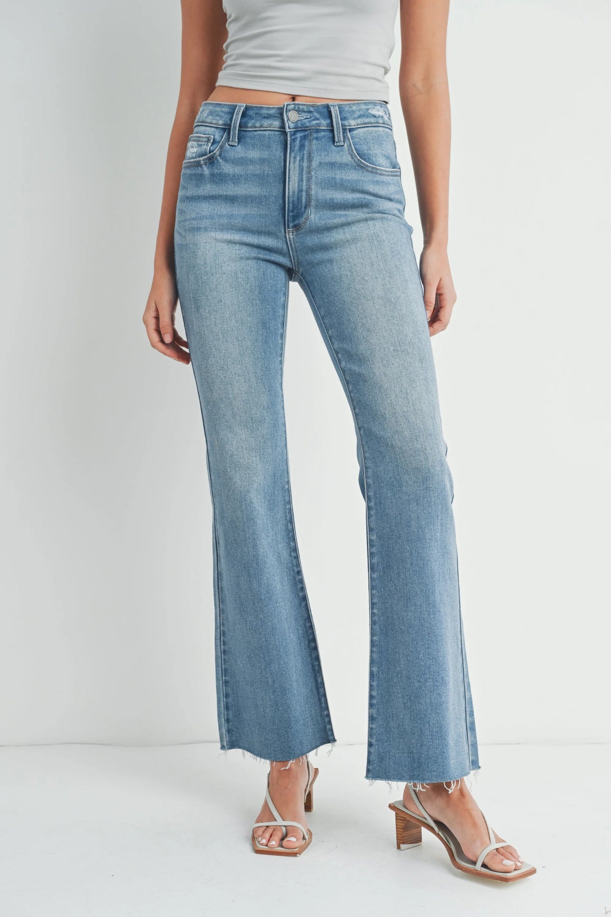 Light blue flared denim jeans with frayed hems for a boho, free spirit look