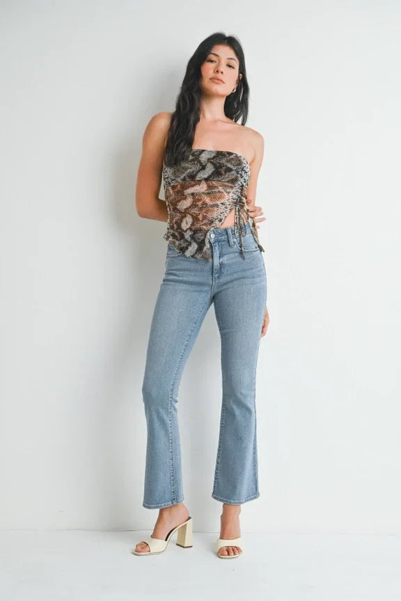 Light blue flared cropped jeans with a strapless top and white heeled sandals from Shop Daisy