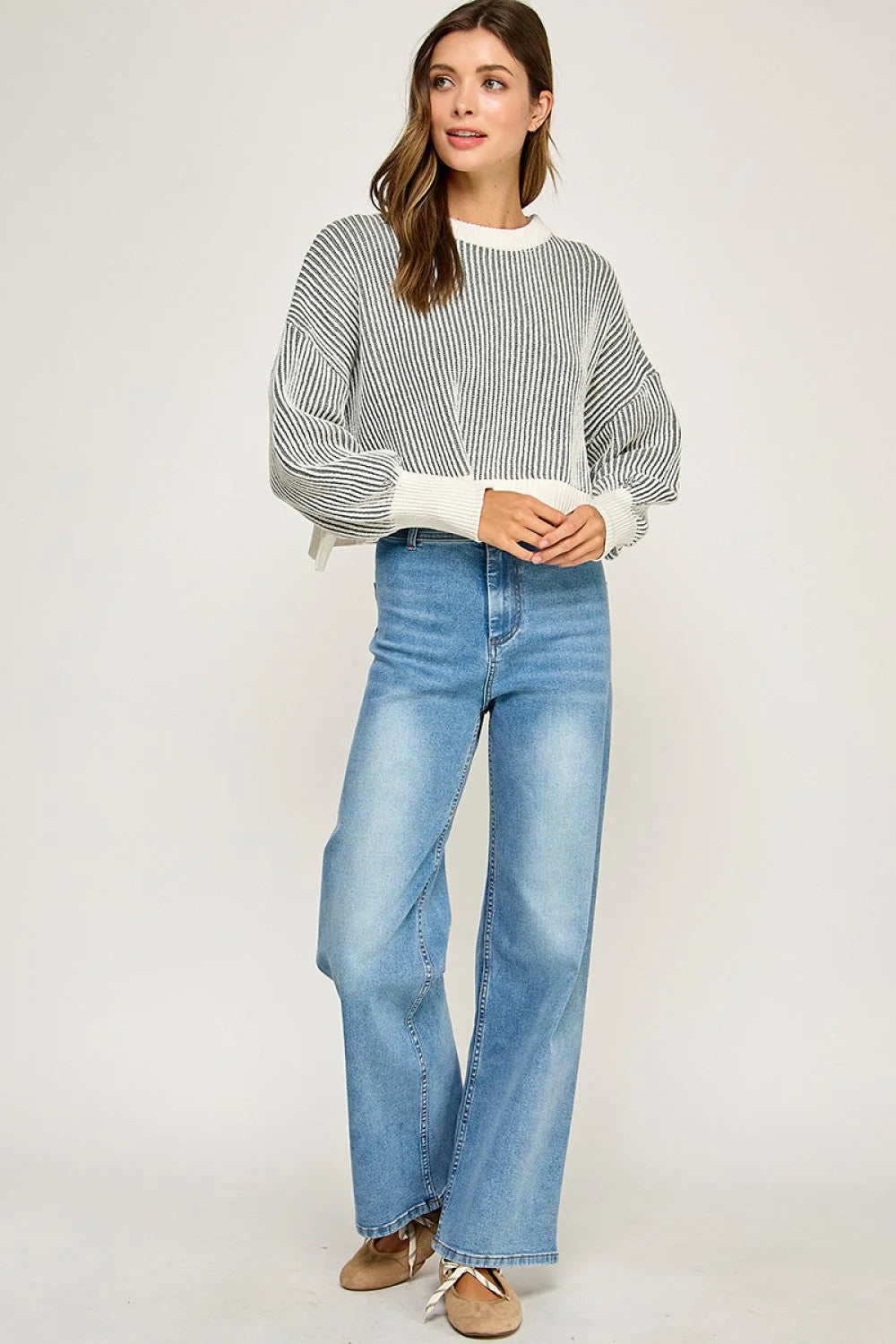 Light blue distressed high-waisted wide-leg jeans with ribbed knit balloon sleeve sweater