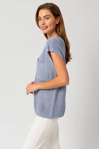 Light blue knitted sweater top with pouch pocket, ideal for women’s boho chic clothing