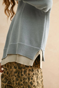 Light blue color combo v-neck sweater with side slits, layered over cream top, with leopard print pants