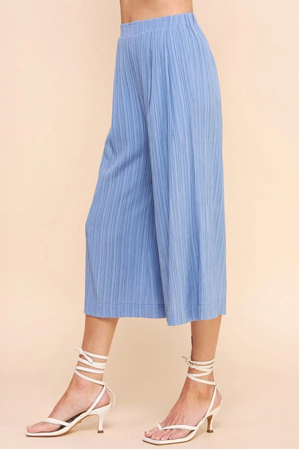 Light blue bamboo textured cropped flowy pants with pleated design and wide-leg cut