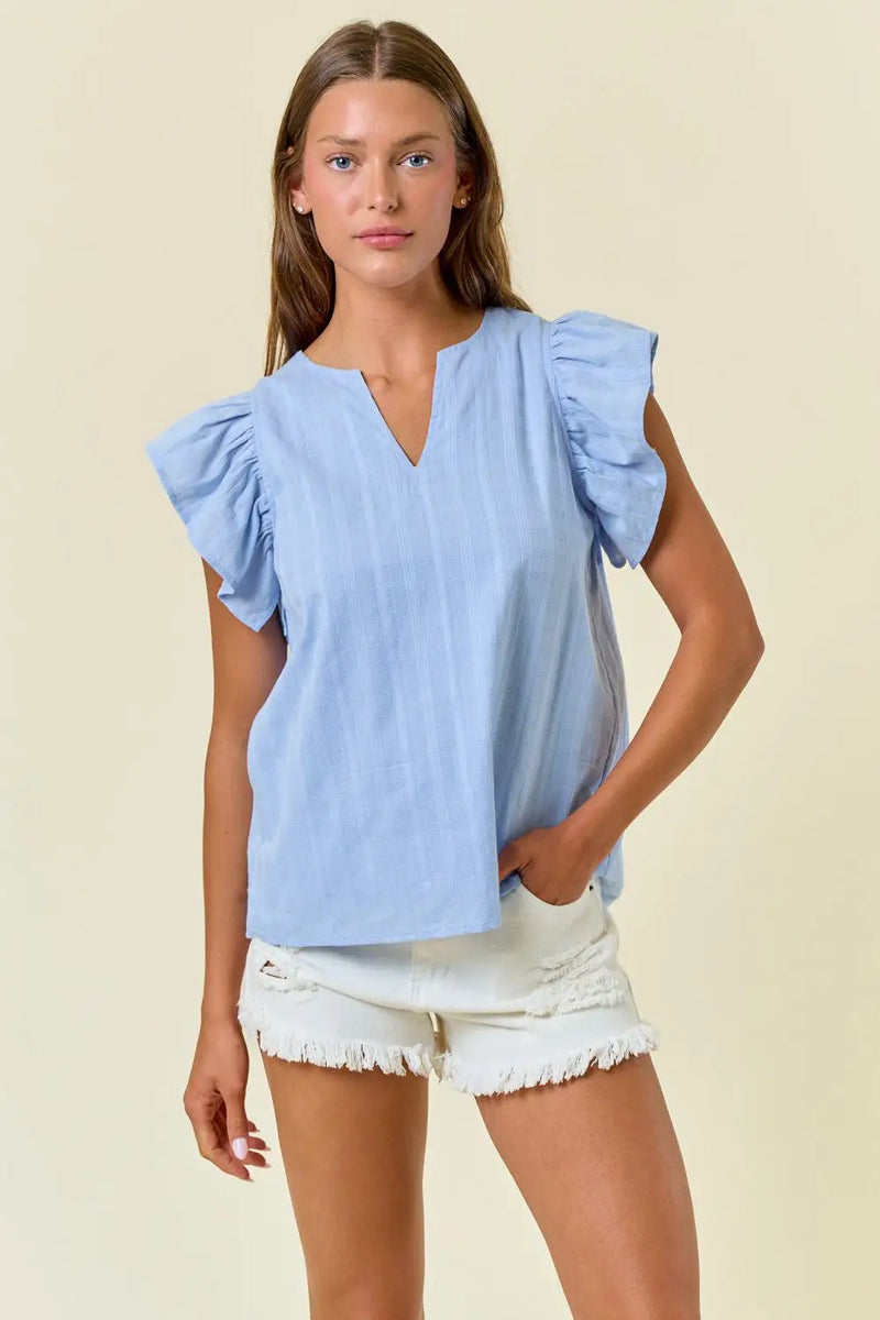 Light blue ruffle-sleeved blouse from Shop Daisy’s womens boho clothes collection