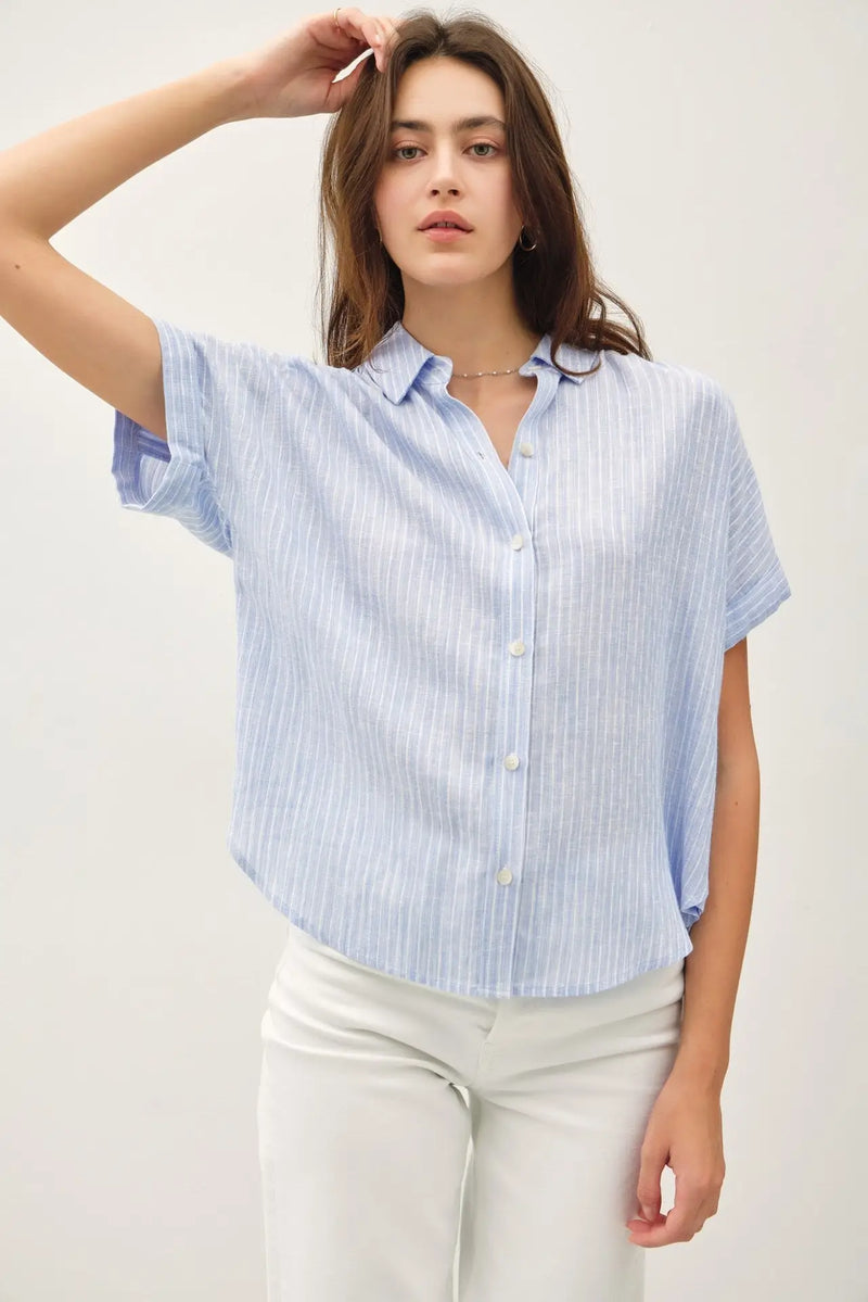 Light blue striped short-sleeved top with shoulder shirring, perfect for women’s boho chic clothing from Shop Daisy