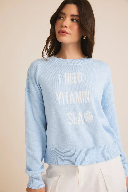 Light blue Vitamin Sea sweater with white text stating I NEED VITAMIN SEA